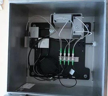 Inside the all-in-one sensor box: tilt sensors, accelerometers and fiber connections in a stainless steel enclosure