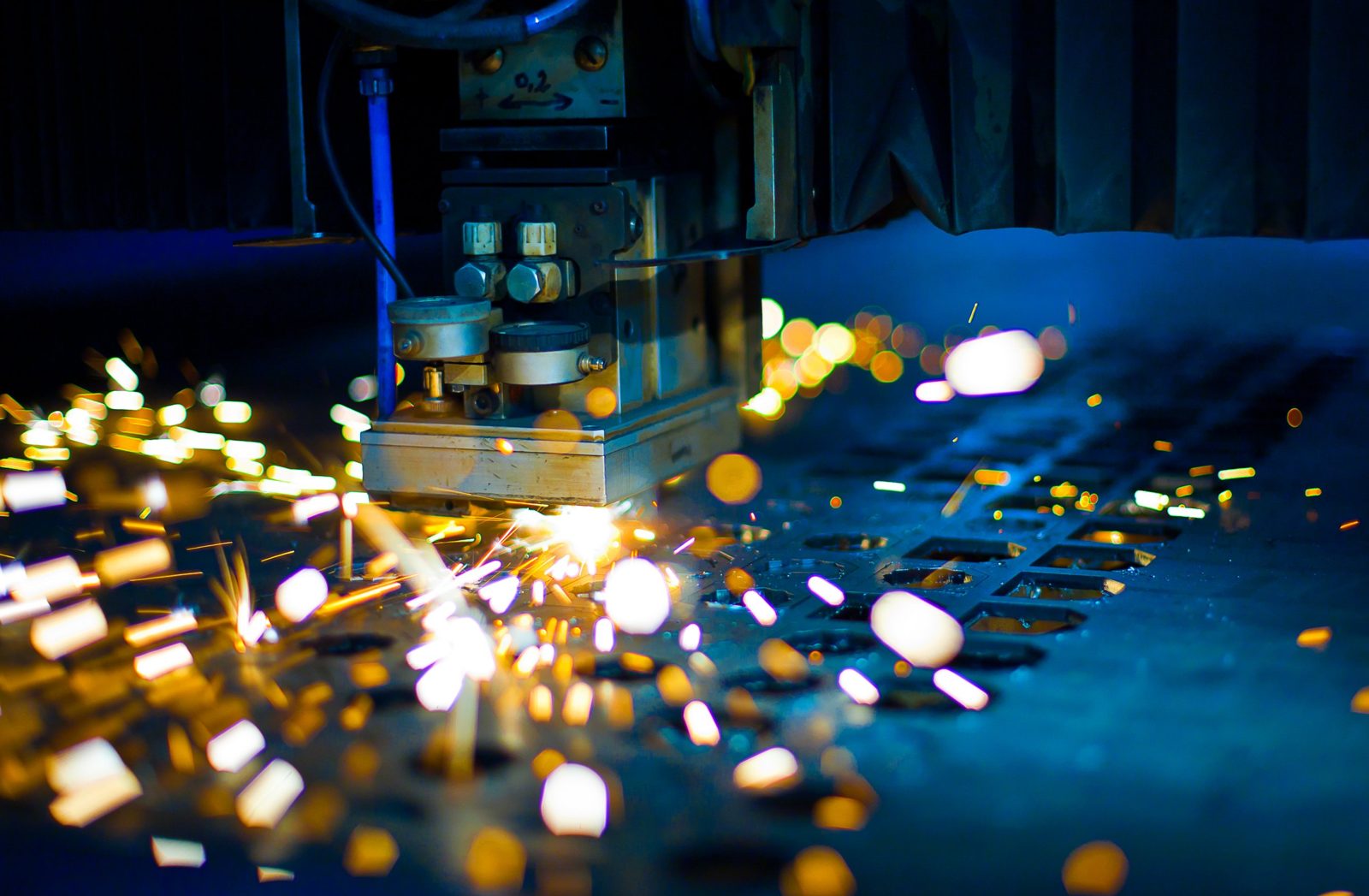 Fiber laser cutting head cutting sheet metal with sparks